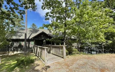 Lake view three bedroom, three bath log-sided cottage with private hot tub overlooking Lake Ouachita. by RedAwning